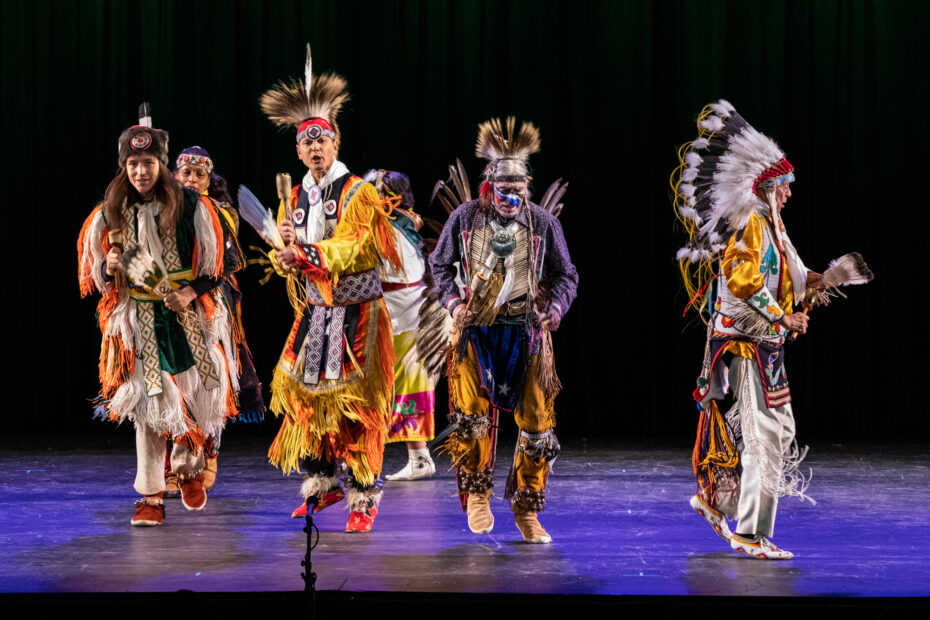 Six members from Thunderbird American Indian Dancers wear brightly colored Native American regalia and dance live onstage at Symphony Space.