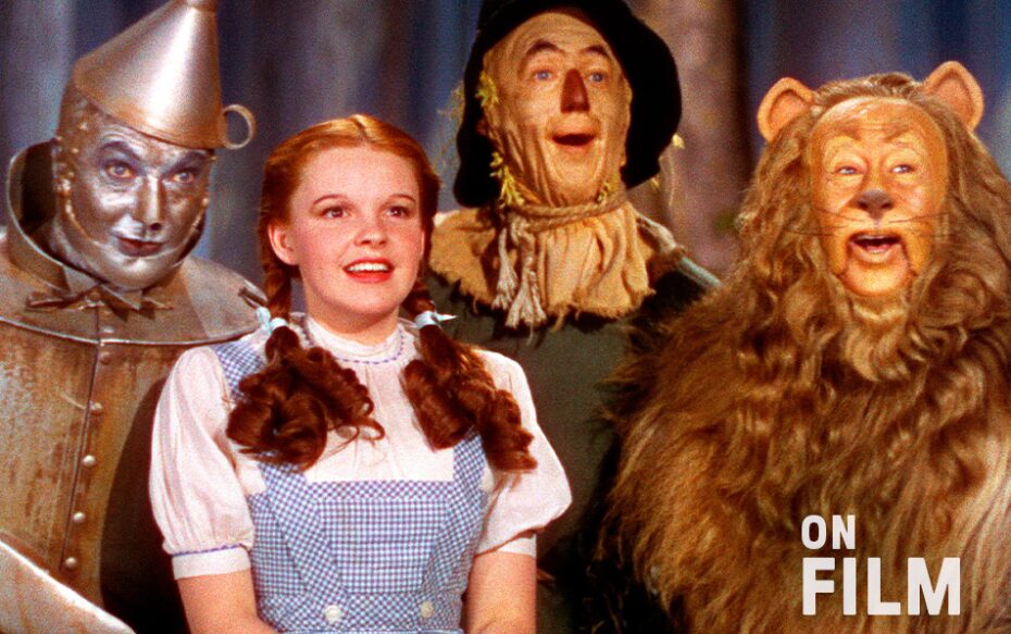 Dorothy, the Tin Man, the Scarecrow, and the Cowardly Lion, all smiling.