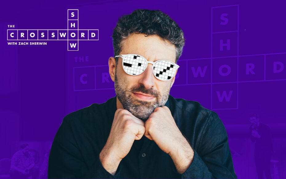 Against a purple background: a headshot of writer and comedian Zach Sherwin, wearing glasses with a crossword puzzle superimposed on the lenses. The logo for The Crossword Show appears in the upper left.
