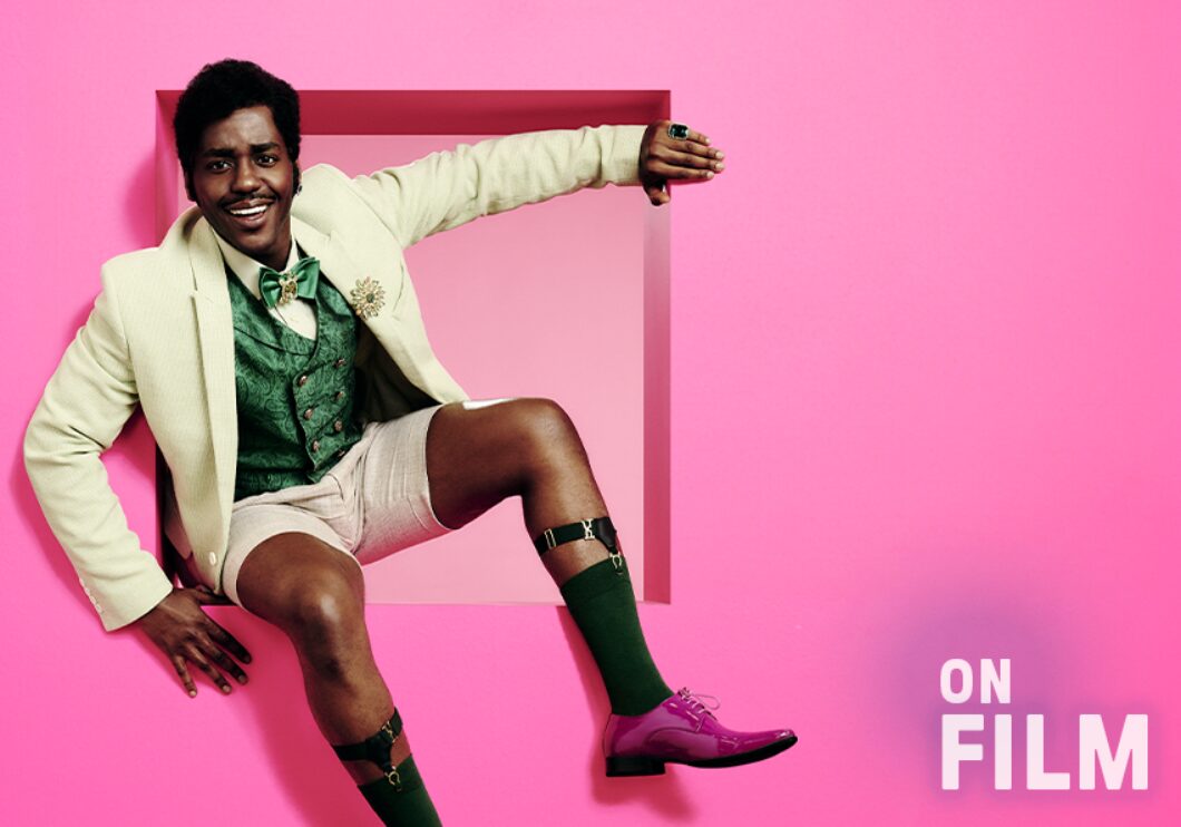 Ncuti Gatwa in The Importance of Being Earnest, in front of a pink background.