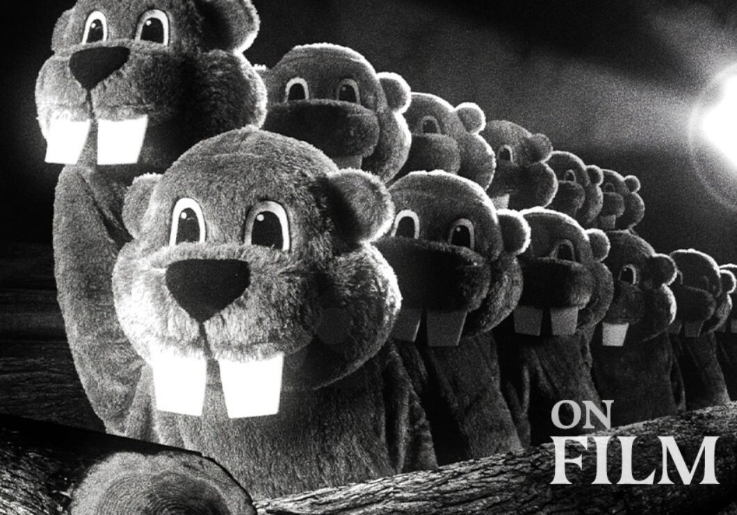 A still from the film Hundreds of Beavers, featuring several beavers in a line.