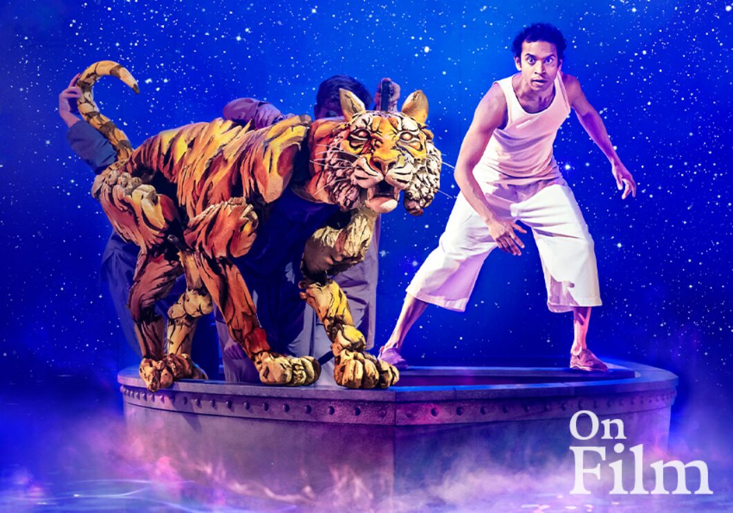 A scene from Life of Pi, featuring a man and a tiger puppet.