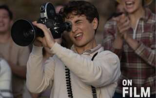 A still from the movie The Fabelmans, featuring a young man looking into a camera.