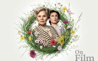 Actors Imelda Staunton and Bessie Carter in Mrs. Warren's Profession, surrounded by a floral wreath.