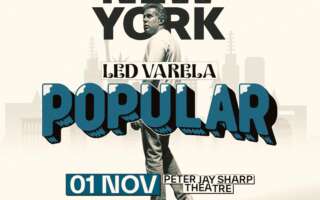 Photo of comedian Led Varela in black and white against a sepia background. The show title and logo in blue text appears in front of his silhouette.