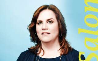 In front of a blue background, Donna Lynne Champlin stands next to the word 'Salon.'