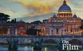 Saint Peter’s Basilica and its surroundings. Its lights are reflecting in the river.