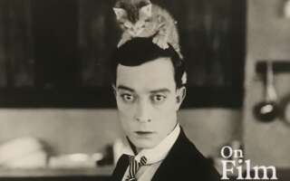Buster Keaton with a kitten on his head.