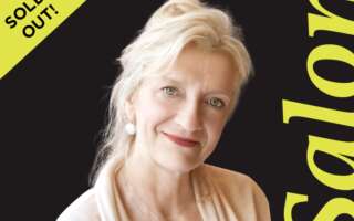 In front of a black background, Elizabeth Strout stands next to the word 'Salon.' In the top left corner it says, "sold out."