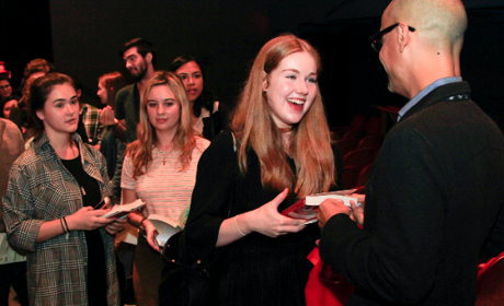 At Symphony Space, an author chats with patrons eager to have their books signed.